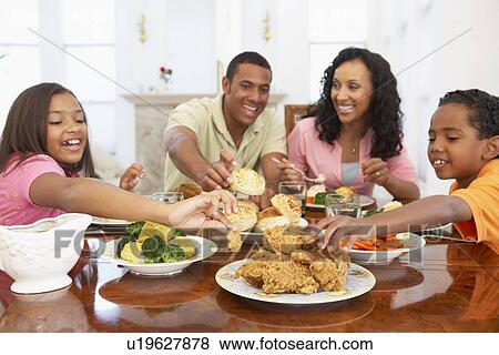 Family Having A Meal Together At Home View Large Photo Image Stock Photo - Family Having A Meal Together At Home. Fotosearch