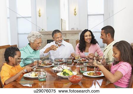 Stock Photography - Family Having A Meal Together At Home. Fotosearch