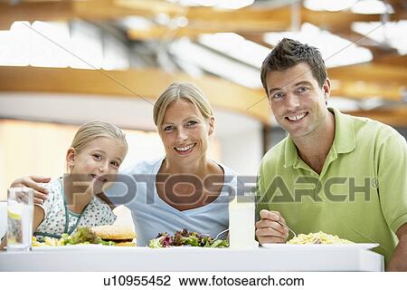 Stock Image - Family Having Lunch Together At The Mall. Fotosearch