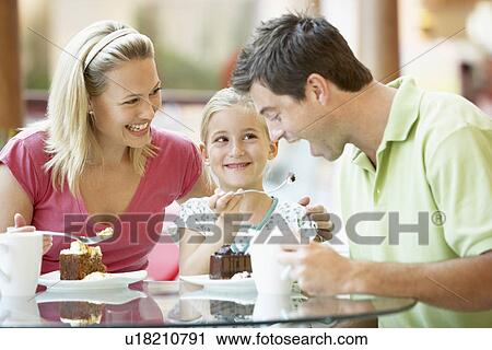Stock Image - Family Having Lunch Together At The Mall. Fotosearch