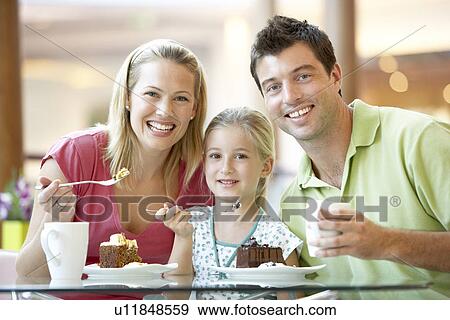 Stock Photo - Family Having Lunch Together At The Mall. Fotosearch