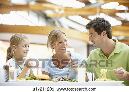 Stock Photography - Family Having Lunch Together At The Mall. Fotosearch