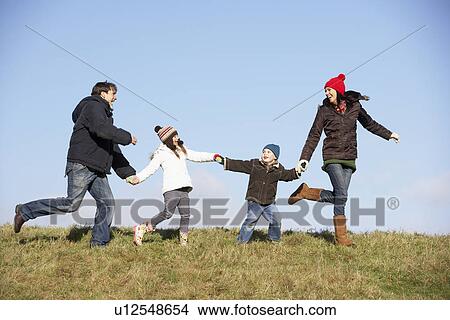 Picture - Family Running In The Park. Fotosearch