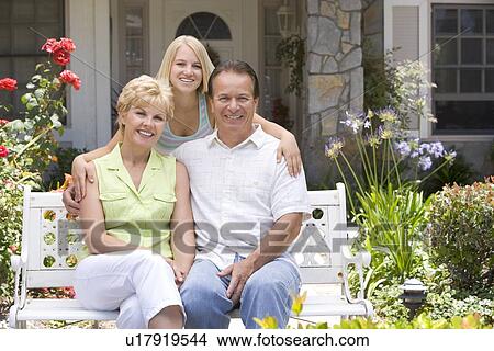 Picture - Family Sitting Outside House. Fotosearch