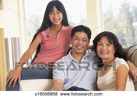 Stock Photo - Family Sitting Together At Home. Fotosearch