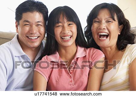 Stock Photo - Family Sitting Together At Home. Fotosearch