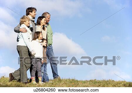 Stock Image - Family Standing In The Park. Fotosearch