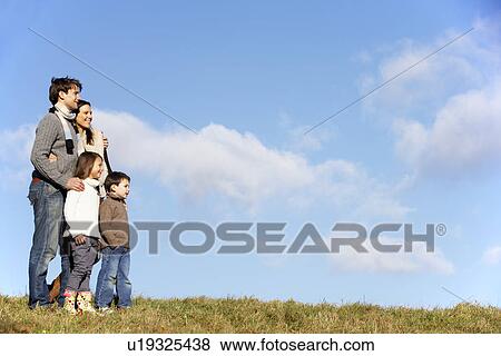 Stock Photo - Family Standing In The Park. Fotosearch