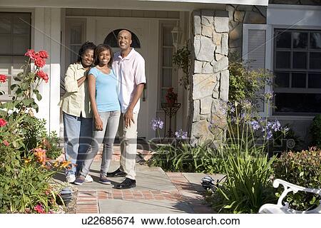 Picture - Family Standing Outside House. Fotosearch