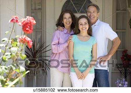Stock Image - Family Standing Outside House. Fotosearch