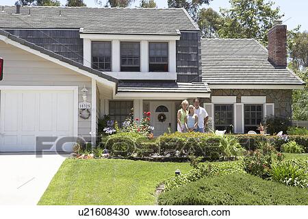 Stock Image - Family Standing Outside House. Fotosearch