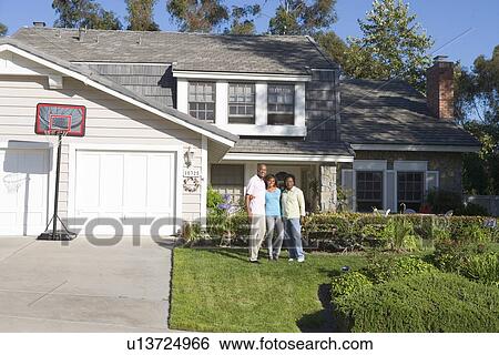 Stock Photograph - Family Standing Outside House. Fotosearch