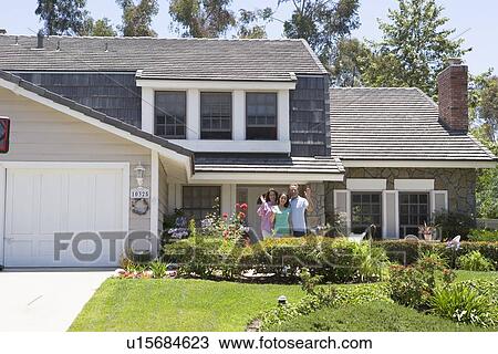 Stock Image - Family Waving Outside House. Fotosearch