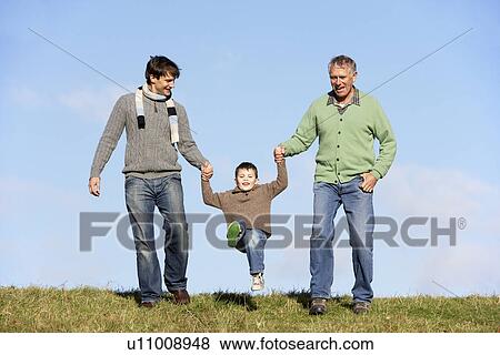 Stock Photo - Father And Grandfather Swinging Young Boy. Fotosearch