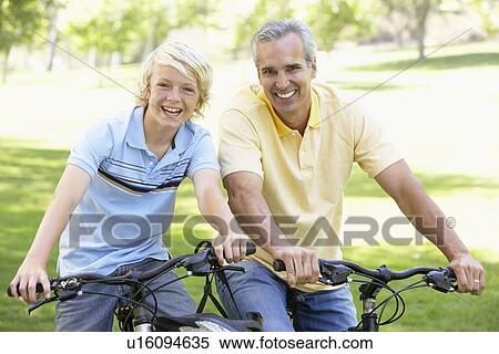 Father And Son Cycling Through A Park View Large Photo Image Stock Photography - Father And Son Cycling Through A Park. Fotosearch