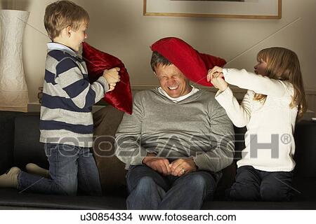 Father And Two Children In Pillow Fight View Large Photo Image Picture - Father And Two Children In Pillow Fight. Fotosearch