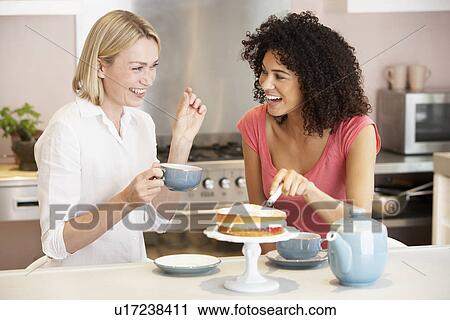 Female Friends Enjoying Tea And Cake At Home View Large Photo Image Stock Image - Female Friends Enjoying Tea And Cake At Home. Fotosearch