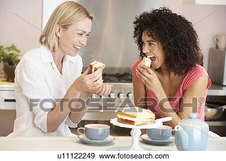 Female Friends Enjoying Tea And Cake At Home View Large Photo Image Stock Photo - Female Friends Enjoying Tea And Cake At Home. Fotosearch