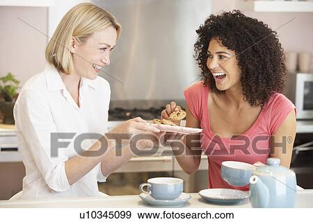 Female Friends Enjoying Tea And Cookies At Home View Large Photo Image Stock Photo - Female Friends Enjoying Tea And Cookies At Home. Fotosearch