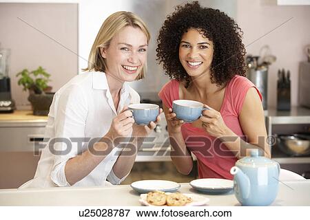 Female Friends Enjoying Tea And Cookies At Home View Large Photo Image Stock Photo - Female Friends Enjoying Tea And Cookies At Home. Fotosearch