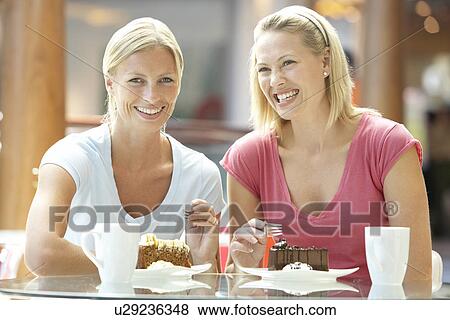 Stock Photo - Female Friends Having Lunch Together At The Mall. Fotosearch