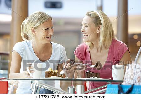 Stock Photograph - Female Friends Having Lunch Together At The Mall. Fotosearch