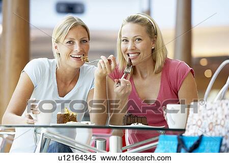 Stock Photography - Female Friends Having Lunch Together At The Mall. Fotosearch