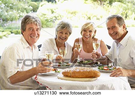 Friends Eating An Al Fresco Lunch, Holding Wineglasses View Large Photo Image Stock Image - Friends Eating An Al Fresco Lunch, Holding Wineglasses. Fotosearch