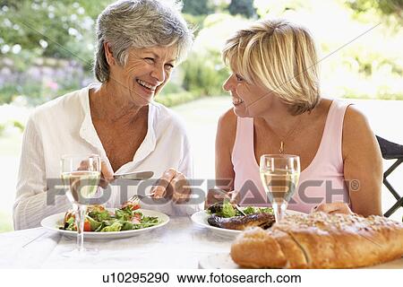 Stock Image - Friends Eating An Al Fresco Meal. Fotosearch