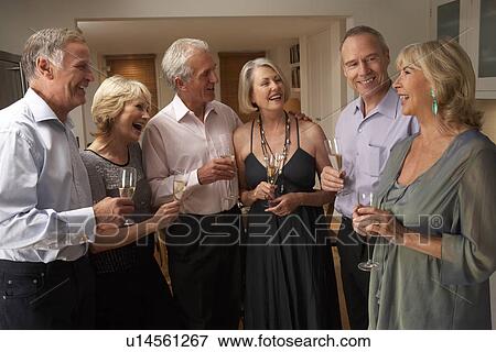 Friends Enjoying A Glass Of Champagne At A Dinner Party View Large Photo Image Stock Photo - Friends Enjoying A Glass Of Champagne At A Dinner Party. Fotosearch