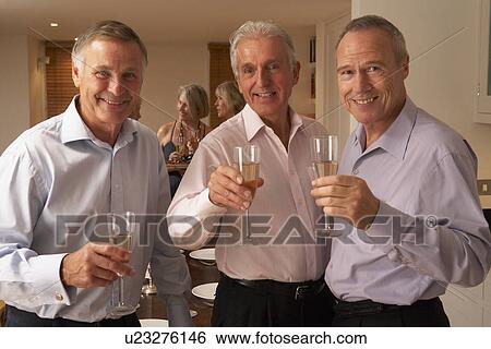 Stock Photograph - Friends Enjoying A Glass Of Champagne At A Dinner Party. Fotosearch