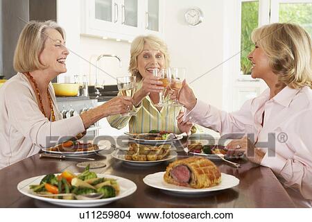 Friends Enjoying Lunch At Home Together View Large Photo Image Picture - Friends Enjoying Lunch At Home Together. Fotosearch
