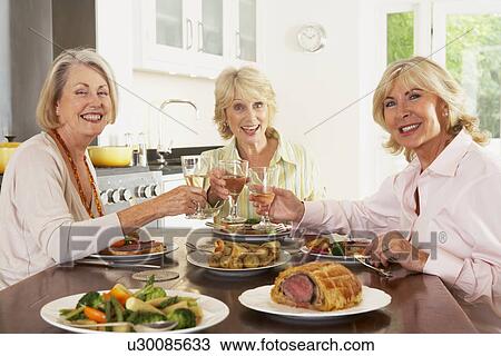 Friends Enjoying Lunch At Home Together View Large Photo Image Stock Image - Friends Enjoying Lunch At Home Together. Fotosearch