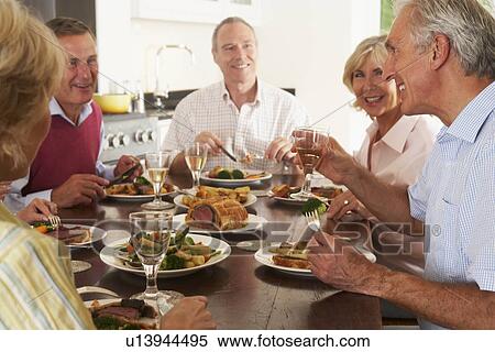 Friends Enjoying Lunch At Home Together View Large Photo Image Stock Photography - Friends Enjoying Lunch At Home Together. Fotosearch