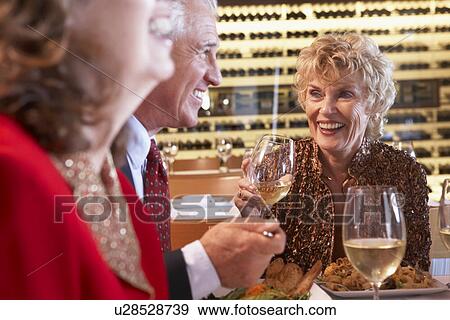 Friends Having Dinner Together At A Restaurant View Large Photo Image Stock Photo - Friends Having Dinner Together At A Restaurant. Fotosearch
