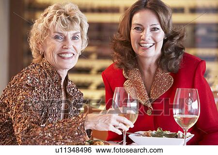 Stock Photograph - Friends Having Dinner Together At A Restaurant. Fotosearch