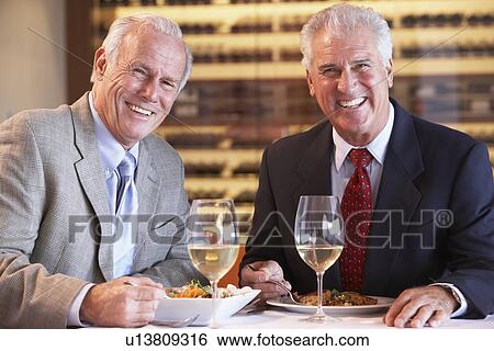 Stock Photograph - Friends Having Dinner Together At A Restaurant. Fotosearch