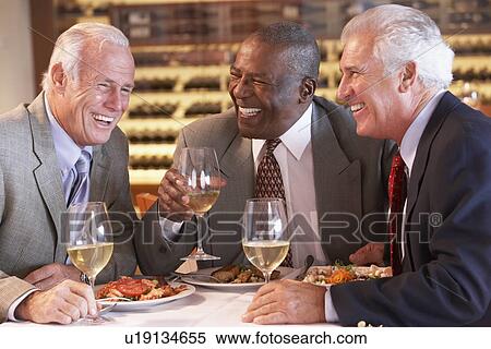 Friends Having Dinner Together At A Restaurant View Large Photo Image Stock Photography - Friends Having Dinner Together At A Restaurant. Fotosearch