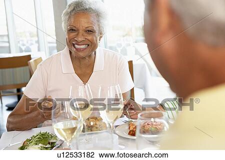 Stock Image - Friends Having Lunch Together At A Restaurant. Fotosearch
