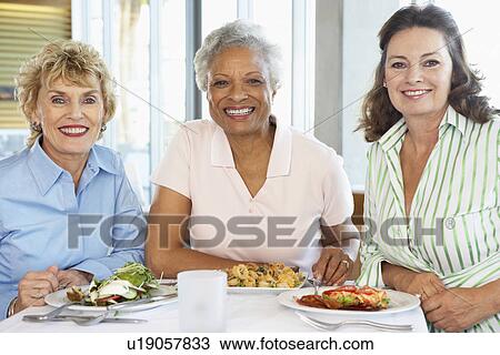Friends Having Lunch Together At A Restaurant View Large Photo Image Stock Image - Friends Having Lunch Together At A Restaurant. Fotosearch