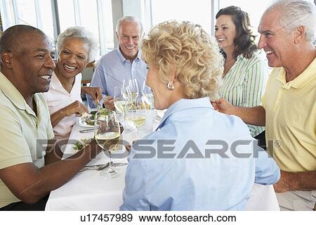 Stock Photo - Friends Having Lunch Together At A Restaurant. Fotosearch