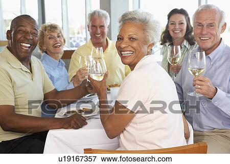 Stock Photo - Friends Having Lunch Together At A Restaurant. Fotosearch