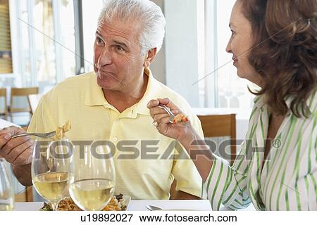 Stock Photo - Friends Having Lunch Together At A Restaurant. Fotosearch