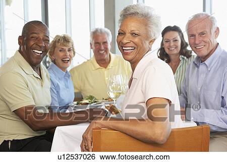 Friends Having Lunch Together At A Restaurant View Large Photo Image Stock Photograph - Friends Having Lunch Together At A Restaurant. Fotosearch