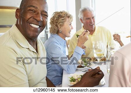 Stock Photography - Friends Having Lunch Together At A Restaurant. Fotosearch
