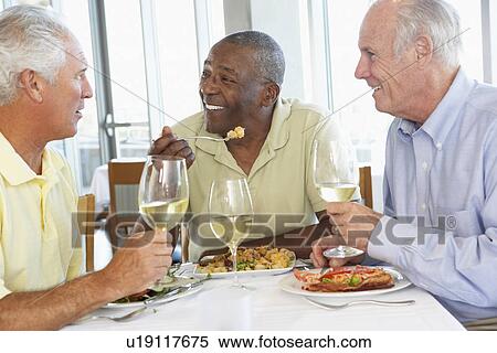 Friends Having Lunch Together At A Restaurant View Large Photo Image Stock Photography - Friends Having Lunch Together At A Restaurant. Fotosearch