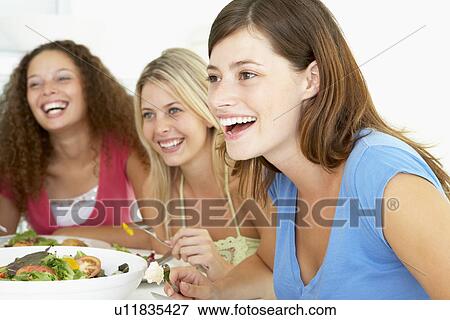 Friends Having Lunch Together At Home View Large Photo Image Stock Photo - Friends Having Lunch Together At Home. Fotosearch