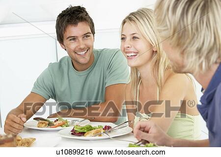Stock Photograph - Friends Having Lunch Together At Home. Fotosearch