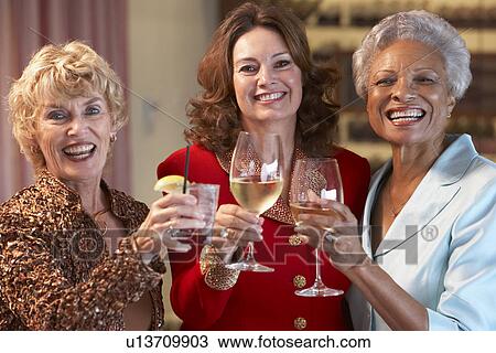 Stock Image - Friends Socializing At A Bar. Fotosearch