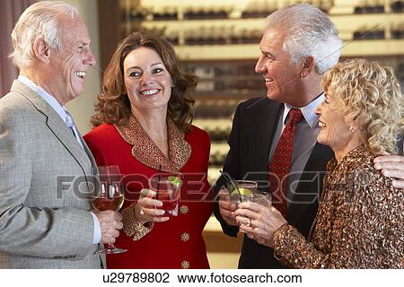 Stock Image - Friends Socializing At A Bar. Fotosearch
